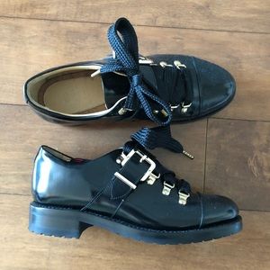 Black patent leather Angela Scott loafers.